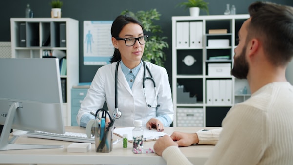 A doctor talking to a patient in a medical office
